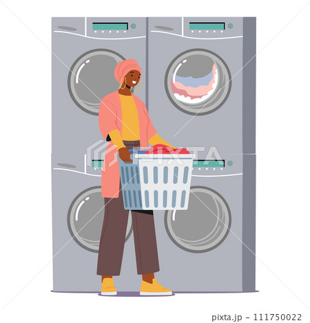 Woman Stands In A Public Laundry. Amidst The Hum Of Laundromat Machines, She Holds Basket With Clothes 111750022