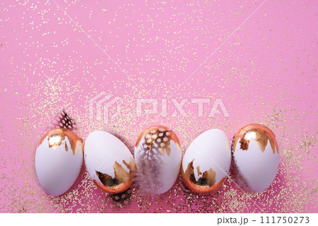 Easter party concept. white Easter eggs with golden glitter on pink background 111750273