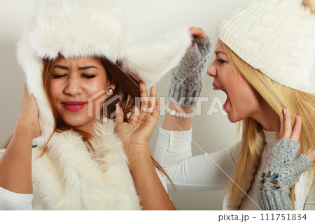 Blonde woman screaming on her friend. 111751834