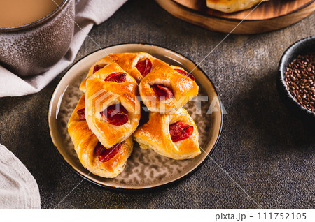 Pepperoni buns with cheese and sausage on a plate on the table 111752105