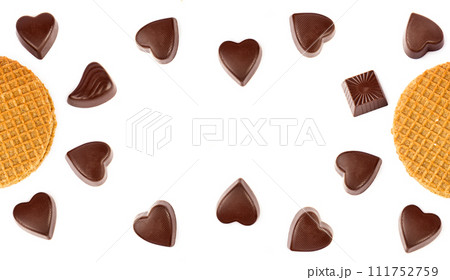 Chocolate candies and Belgian waffles isolated on white. There is free space for text. Collage. Wide photo. 111752759