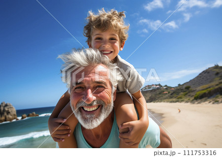 Little boy playing with his grandfather on the sea beach Little boy playing with his grandfather on the sea beach 111753316