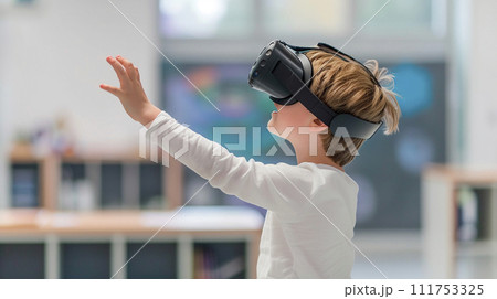 Happy young schoolboy in VR glasses smiling and gesturing with his hands while interacting with his virtual environment 111753325