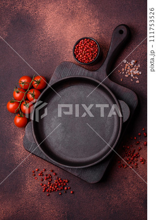 Empty ceramic round plate on dark textured concrete background Empty ceramic round plate on dark textured concrete background 111753526