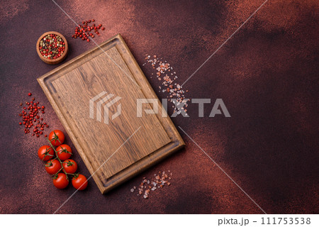 Empty rectangular wooden cutting board on textured concrete background Empty rectangular wooden cutting board on textured concrete background 111753538