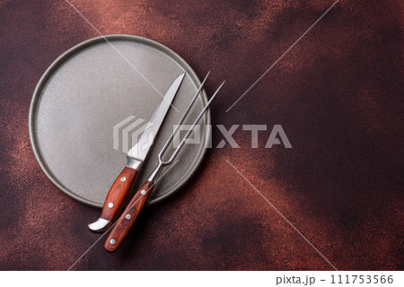 Empty ceramic round plate on dark textured concrete background 111753566
