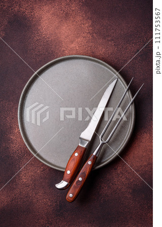 Empty ceramic round plate on dark textured concrete background 111753567