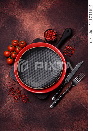 Empty ceramic round plate on dark textured concrete background Empty ceramic round plate on dark textured concrete background 111753616