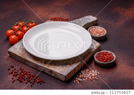 Empty ceramic round plate on dark textured concrete background 111753617