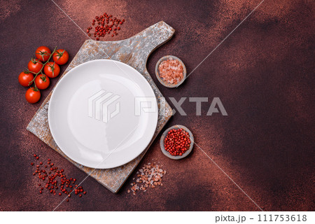 Empty ceramic round plate on dark textured concrete background 111753618