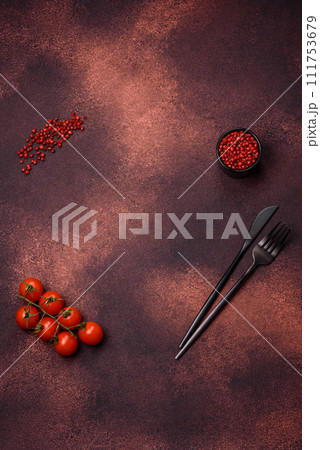 Empty concrete kitchen surface with salt, allspice and cherry tomatoes, copy space 111753679