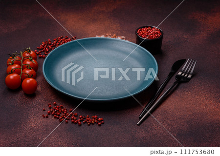 Empty ceramic round plate on dark textured concrete background 111753680