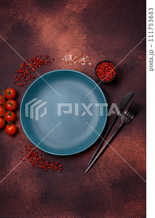 Empty ceramic round plate on dark textured concrete background 111753683