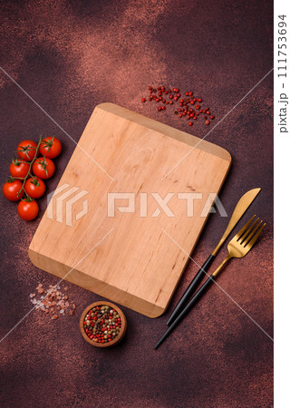 Empty rectangular wooden cutting board on textured concrete background 111753694
