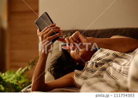 Hands of restful girl holding smartphone 111754303