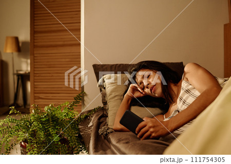 Girl looking at screen of mobile gadget 111754305