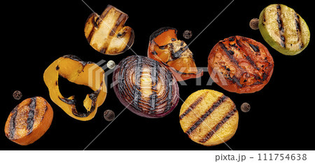Falling grilled vegetable slices on black background 111754638