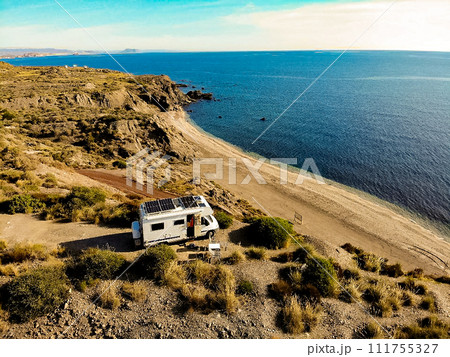 Caravan with solar panels on roof camp on coast, Spain. Aerial view. 111755327