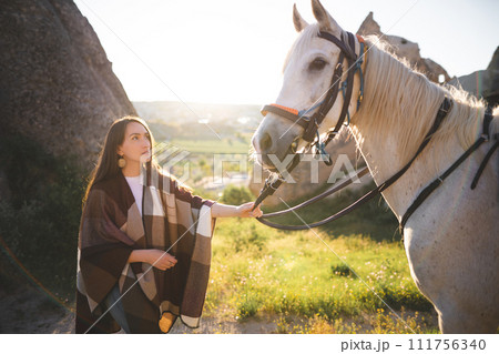 beautiful girl outdoors in the mountains with her faithful horse 111756340