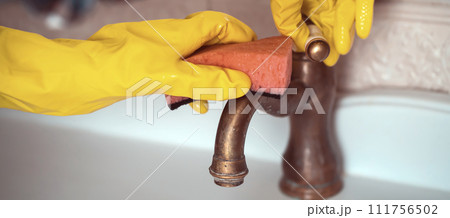 Girl in rubber gloves is cleaning bathroom. 111756502