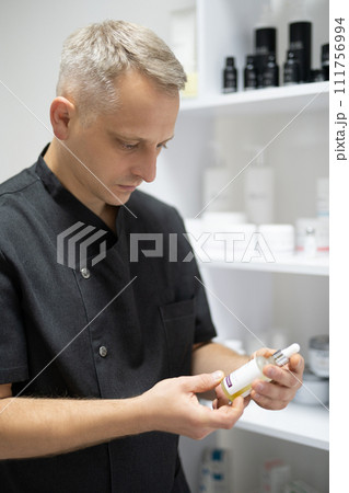 man doctor, cosmetologist  holds drugs in his hands 111756994