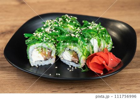 delicious traditional Japanese sushi and rolls on a plate delicious traditional Japanese sushi and rolls on a plate 111756996