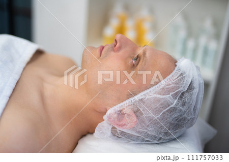cosmetic procedures on a man's face in a beauty salon 111757033
