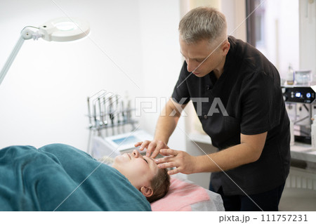 girl at a cosmetologist during treatment procedures girl at a cosmetologist during treatment procedures 111757231