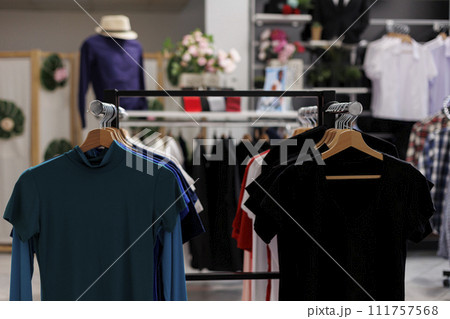 Modern boutique with colorful t-shirt and stylish accessories. Empty clothing store filled with new fashion collection and fashionable clothes waiting for customers to come and shop Modern boutique with colorful t-shirt and stylish accessories. Empty clothing store filled with new fashion collection and fashionable clothes waiting for customers to come and shop 111757568