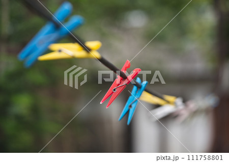 different colors of clothespins for washed clothes on a string different colors of clothespins for washed clothes on a string 111758801