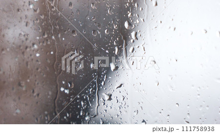 Macro of water drops on glass. Large rain drops strike window during winter shower. Pure rain drops. Macro of water drops on glass. Large rain drops strike window during winter shower. Pure rain drops. 111758938