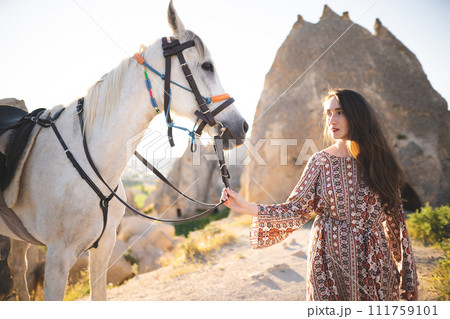 beautiful girl outdoors in the mountains with her faithful horse 111759101