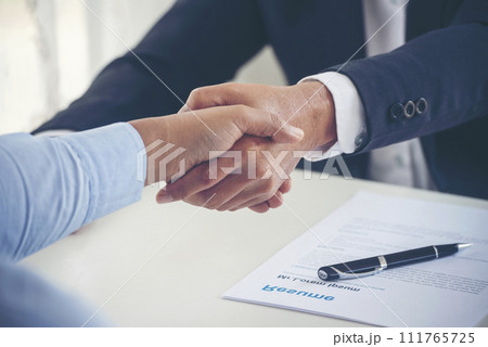 Team Business Partners shaking hands together to Greeting Start up new project. Shakehand Teamwork Partnership at office desk. Businessman partners handshake together.  Business concept 111765725