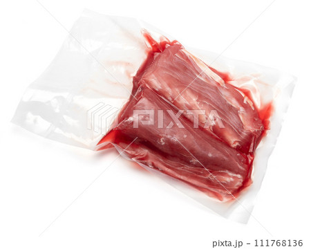 close-up Vacuum packed tuna fillet pieces in transparent plastic for preserving the freshness isolated on white background 111768136
