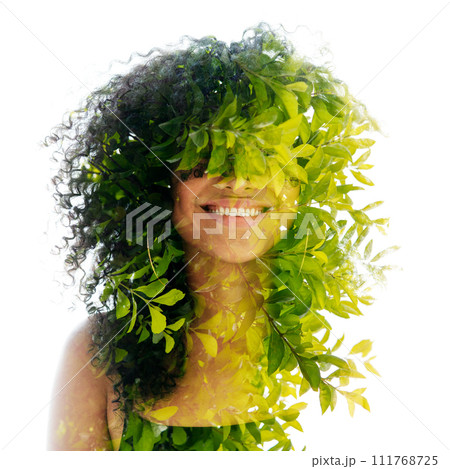 A double exposure portrait of a young woman with frizzy hair merged with leaves A double exposure portrait of a young woman with frizzy hair merged with leaves 111768725