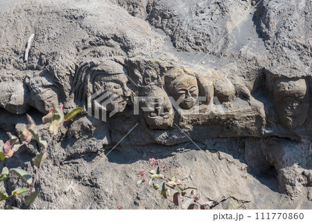 The mystery face carved into rock at entrance of Bentar Candi and Batok volcano in Bromo Tengger Semeru National Park, East Java, Indonesia. 111770860