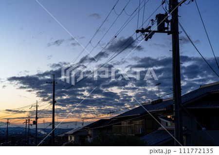 早春の住宅街を照らす夕焼け空 黄金色の空に浮かぶ夕焼け雲と青空のグラデーション 夕暮れの街並み 早春の住宅街を照らす夕焼け空 黄金色の空に浮かぶ夕焼け雲と青空のグラデーション 夕暮れの街並み 111772135