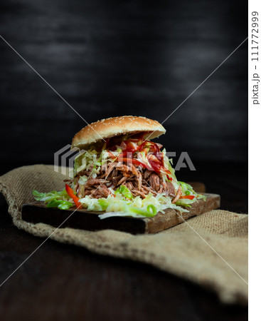 Pulled pork sandwich with coleslaw, buns and seasoning. Pulled pork burgers 111772999
