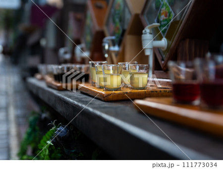 Assortment of hard strong alcoholic drinks and spirits in glasses on bar counter Assortment of hard strong alcoholic drinks and spirits in glasses on bar counter 111773034
