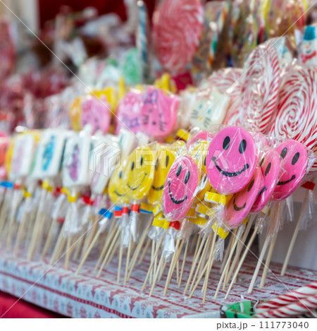 Candy lollipops with smiling emoticon on the christmas stand 111773040