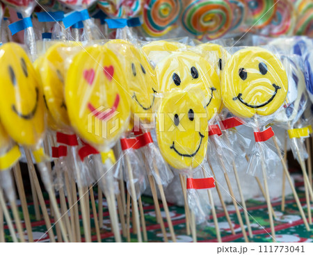 Candy lollipops with smiling emoticon on the christmas stand 111773041