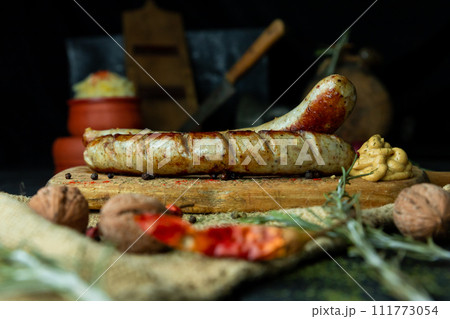Bratwurst sausages served with mustard and herbs 111773054