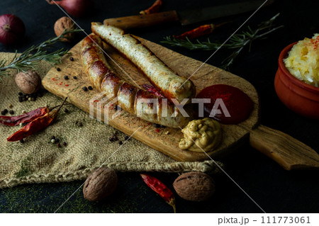 Bratwurst sausages served with mustard and herbs Bratwurst sausages served with mustard and herbs 111773061