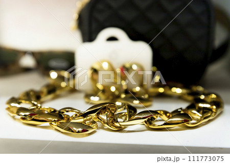 Golden chain necklace on a display in jewellery store 111773075