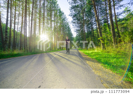 Man jogging in city partk at beautiful summer day. Sport fitness model caucasian ethnicity training outdoor. 111773094