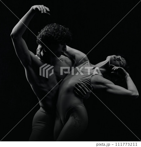 Portrait of passion and love. Talented, artistic young man and woman, ballet dancers making performance. Black and white Portrait of passion and love. Talented, artistic young man and woman, ballet dancers making performance. Black and white 111773211