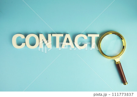 Contact alphabet letters with magnifying glass on blue background Contact alphabet letters with magnifying glass on blue background 111773837