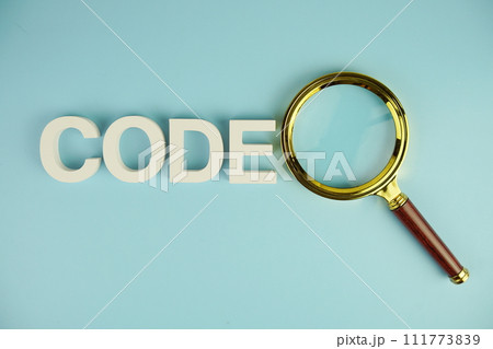 Code alphabet letters with magnifying glass on blue background Code alphabet letters with magnifying glass on blue background 111773839