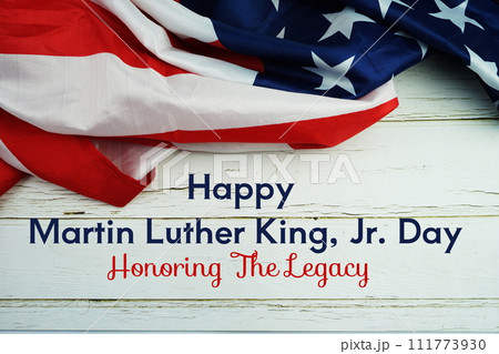 Happy Martin Luther King Jr Day text messege with USA flag on wooden background Happy Martin Luther King Jr Day text messege with USA flag on wooden background 111773930
