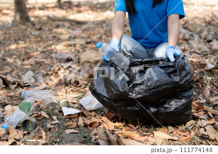 Young people friend volunteer collecting garbage plastic bottles to trash bags. environmental care ecology concept 111774148